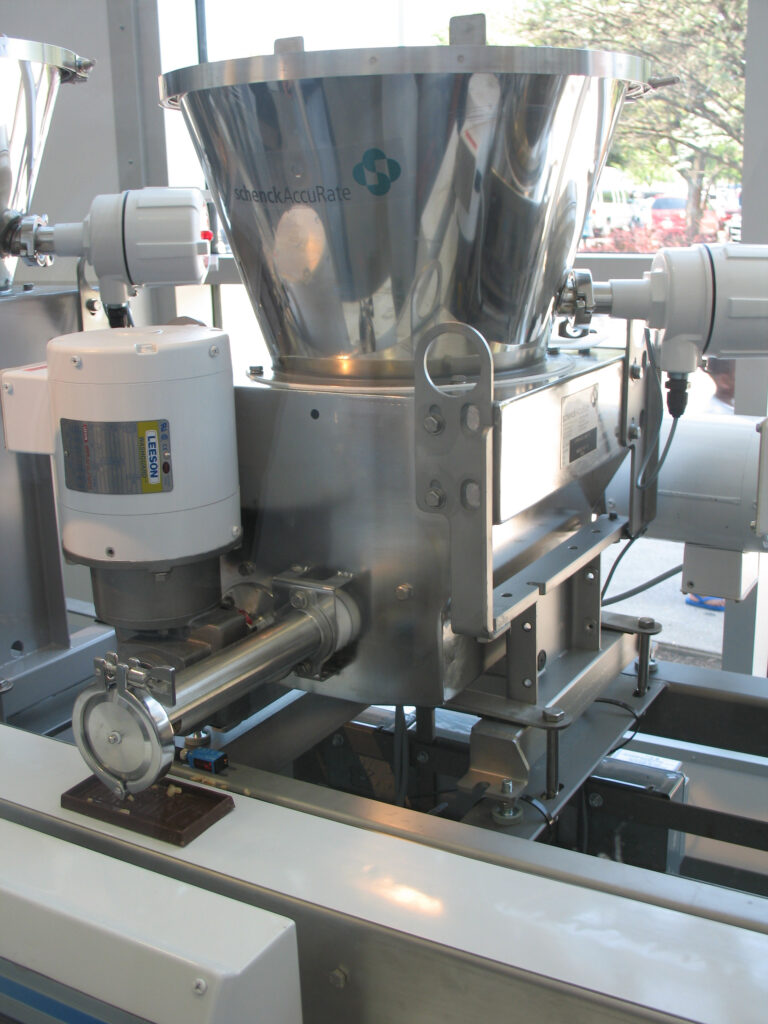 Chocolate bar processing volumetric feeders